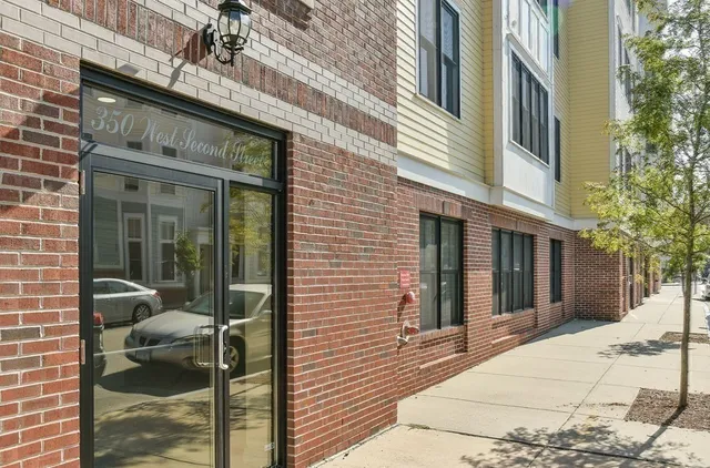 a view of a brick house with a large windows