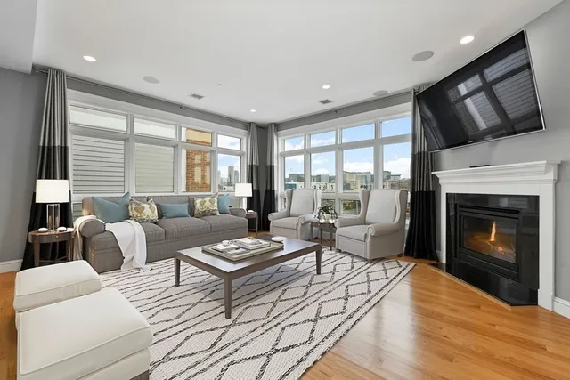 a living room with furniture a fireplace and a flat screen tv