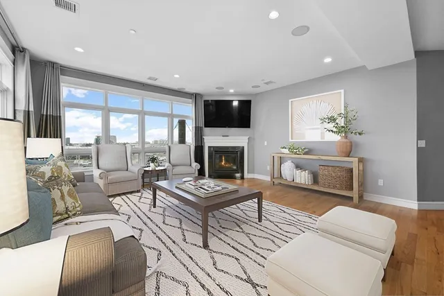 a living room with furniture a fireplace and a flat screen tv