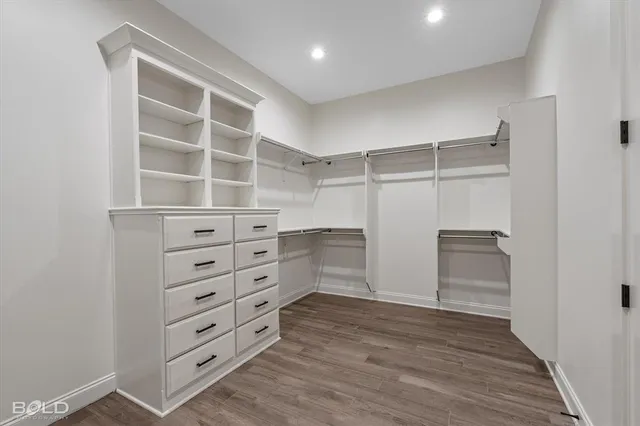 a view of walk in closet with empty racks