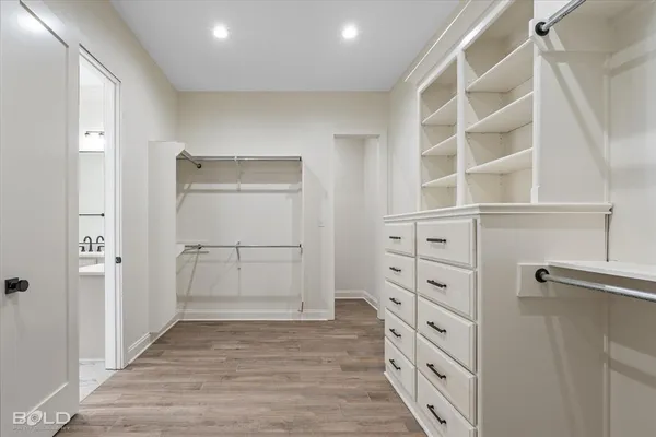 a view of walk in closet with empty racks
