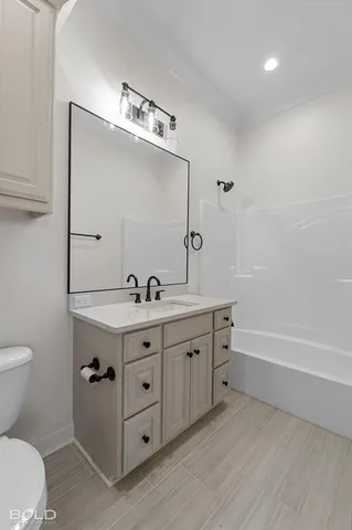 a bathroom with a double vanity sink mirror and toilet