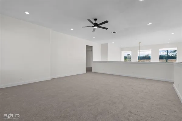 a view of a livingroom with a ceiling fan and window
