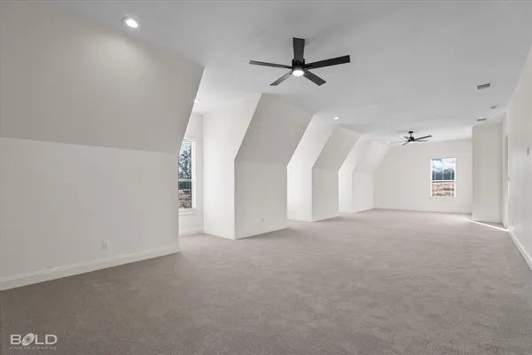 a view of a big room with closet and windows