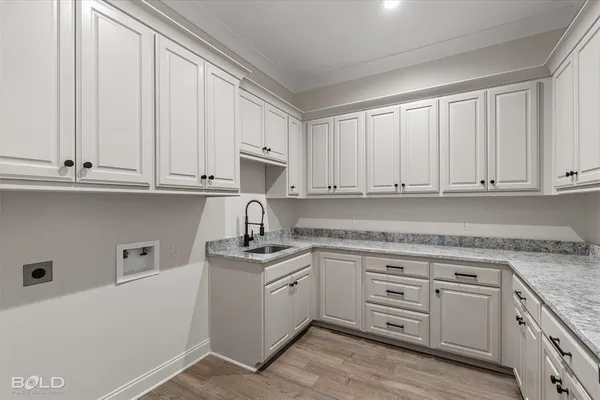 a kitchen with granite countertop white cabinets and white appliances