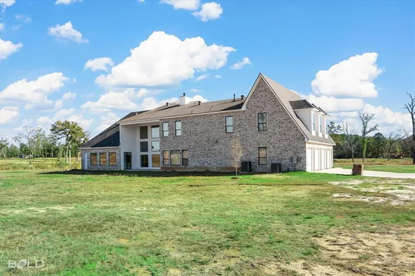 a view of a house with a yard and sitting area