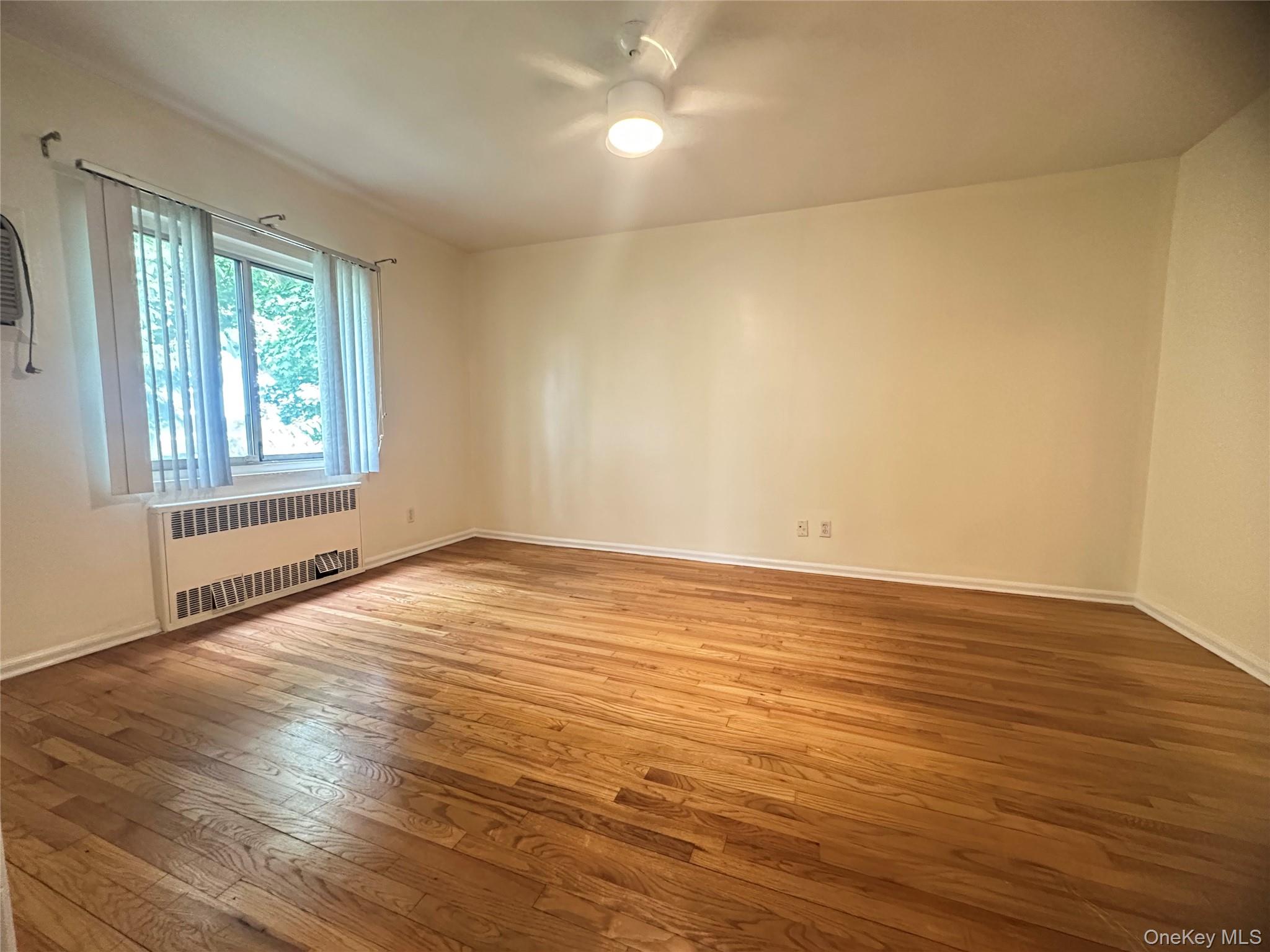 129 Fenimore Road, Unit 129B Mamaroneck, NY 10543 - Photo 9 of 19 Bedroom 2, with in-wall AC, 2 door storge closet, ceiling fan.