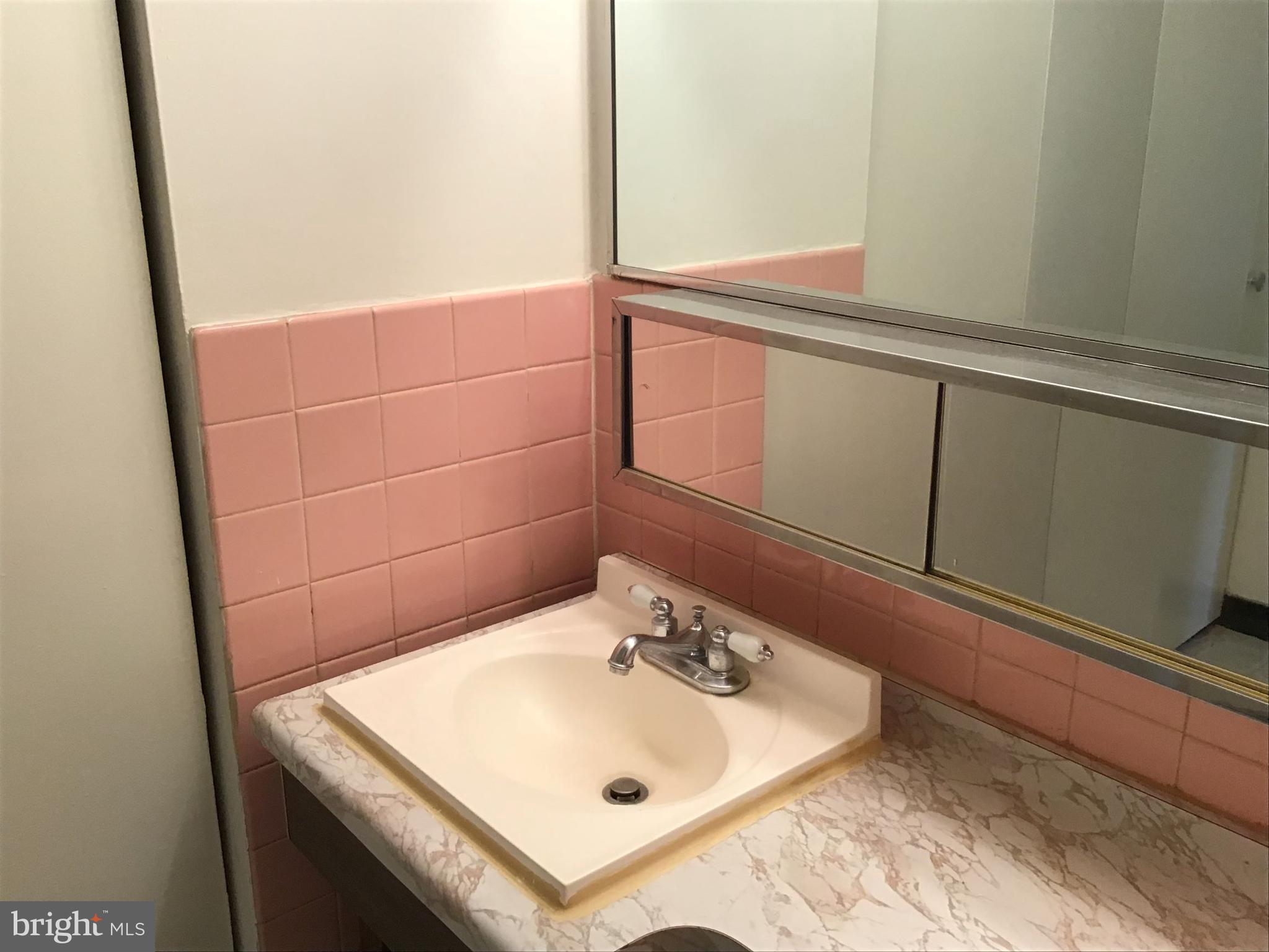 1440 N Street Northwest, Unit 812 Washington, DC 20005 - Photo 7 of 23 a bathroom with a sink and a mirror