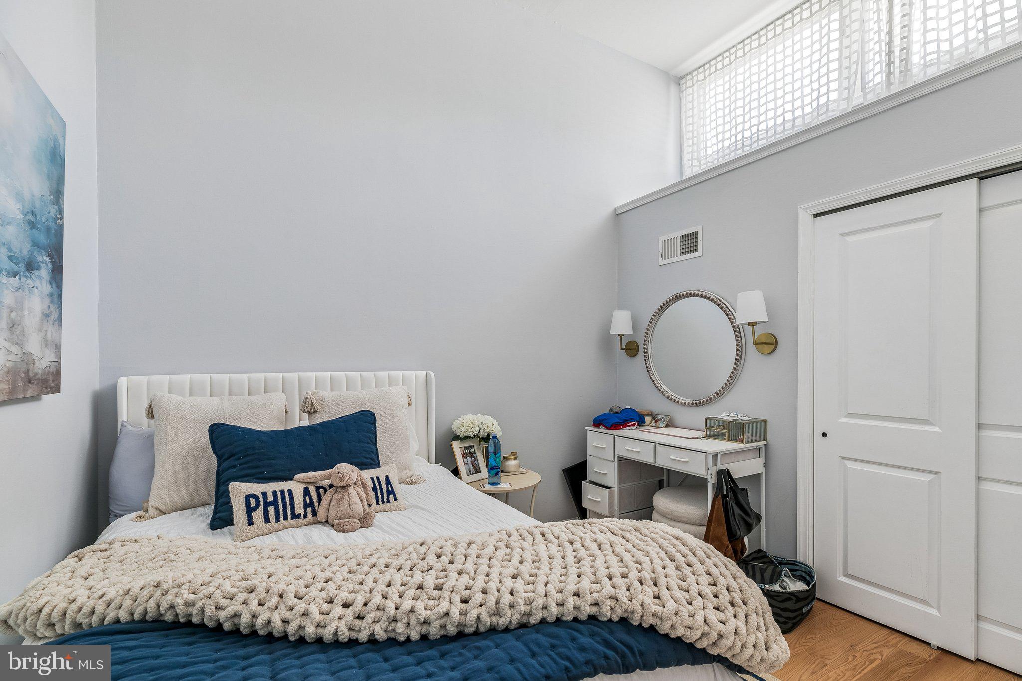 1130 Lombard Street Philadelphia, PA 19147 - Photo 26 of 45 a bedroom with a bed a mirror and a window