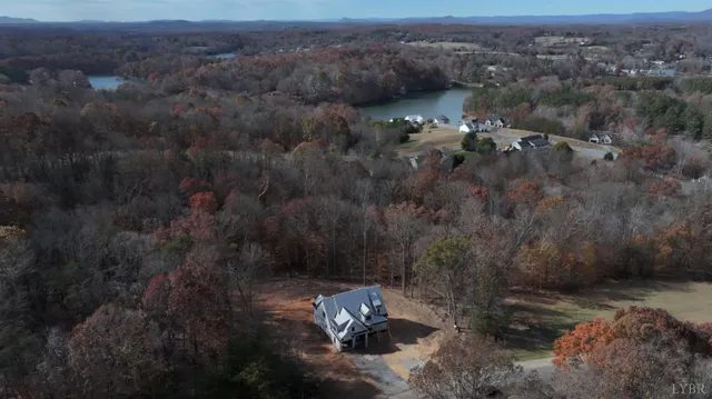 a view of a chairs setting on the deck in front of house
