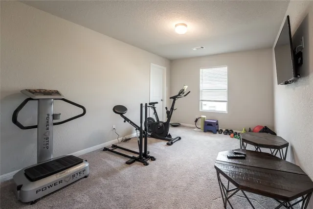 a bedroom with bed couch and window