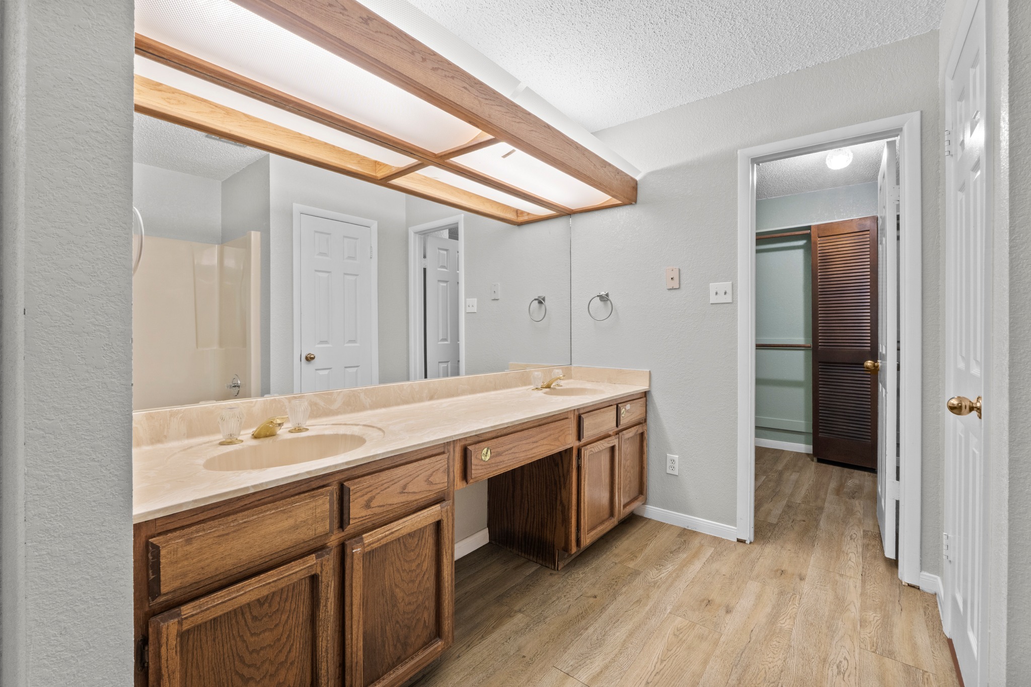 205 Sedro Trail Georgetown, TX 78633 - Photo 26 of 32 Double vanity with ample counter space and warm wood cabinetry graces this primary bathroom.
