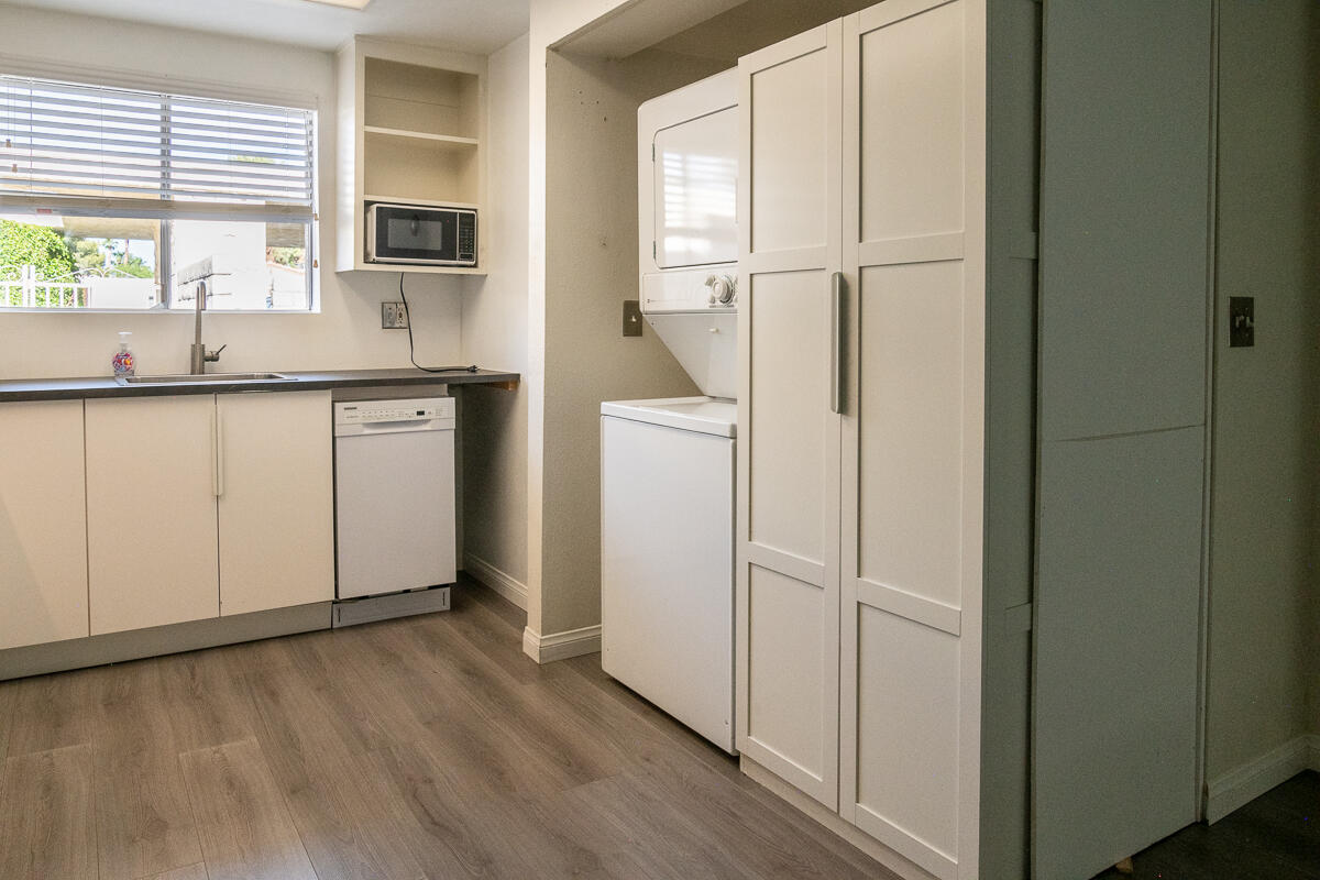 48941 Eisenhower Drive Indio, CA 92201 - Photo 5 of 17 a kitchen with white cabinets and a refrigerator