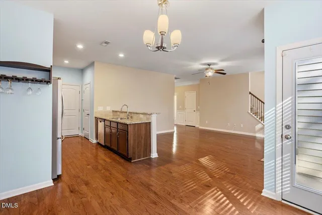 a view of a room with a window and wooden floor