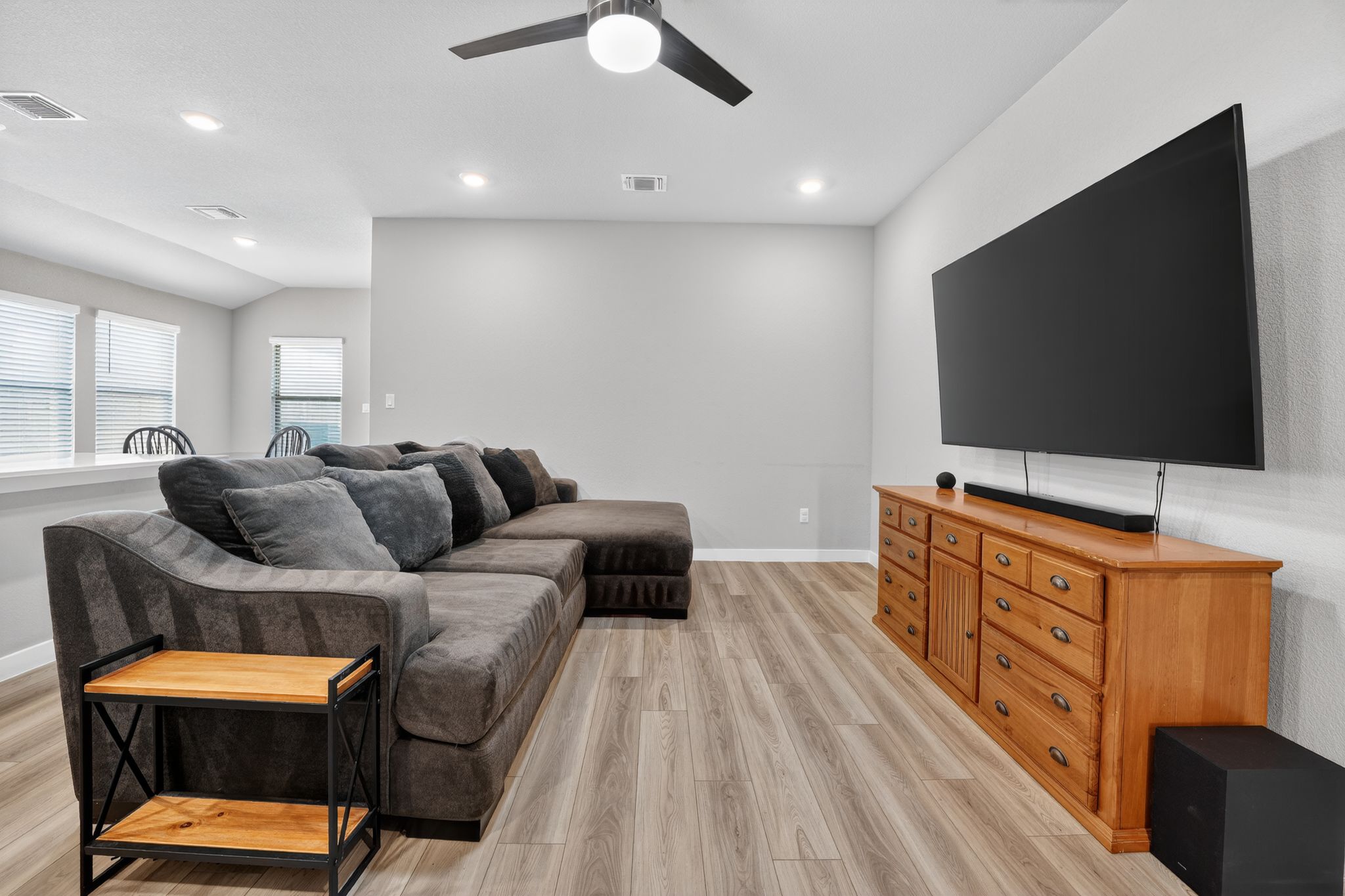 117 Halford Road Georgetown, TX 78633 - Photo 7 of 31 Living room featuring ceiling fan, recessed lighting, light wood finished floors, and vaulted ceiling