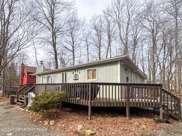 a view of a house with a wooden deck