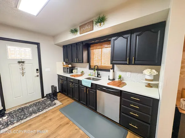 a kitchen with a sink stove and cabinets