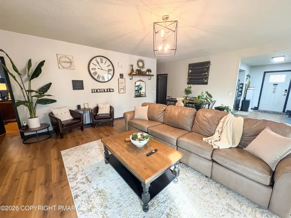a living room with furniture and a clock