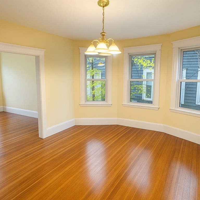 71-73 Turner Street, Unit 73 Boston, MA 02135 - Photo 6 of 14 a view of an empty room with wooden floor and a window