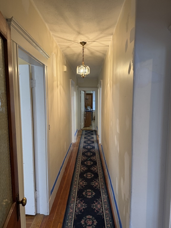 71-73 Turner Street, Unit 73 Boston, MA 02135 - Photo 8 of 14 a view of a hallway with wooden floor and staircase