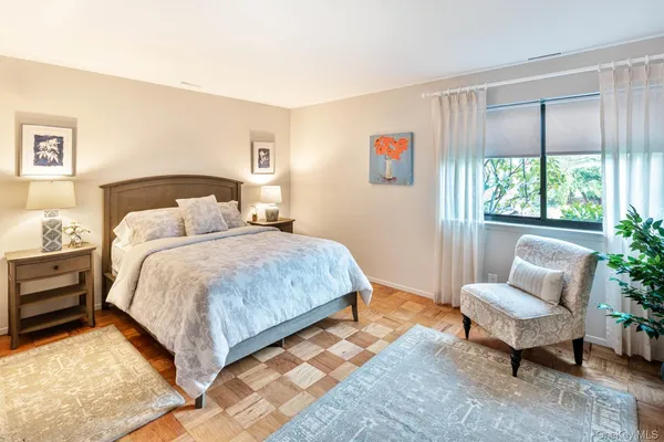 a spacious bedroom with a bed and a couch