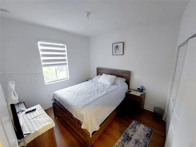 a bed sitting in a bedroom next to a window