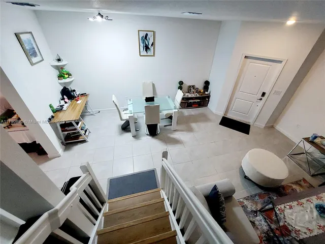 a living room with furniture and a mirror