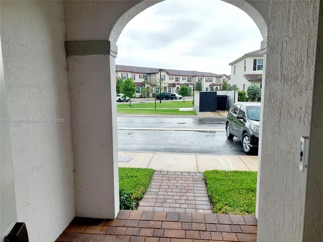 a view of backyard with plants and outdoor seating
