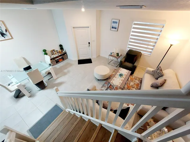 a view of living room with furniture and wooden floor
