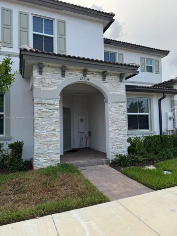 a front view of a house with garden