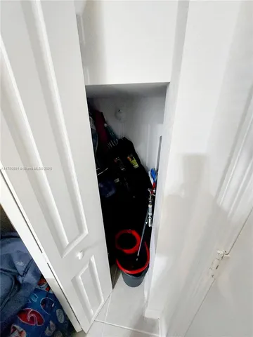 a living room with furniture and white walls