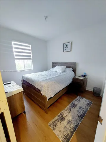 a swimming pool with outdoor seating and yard in back