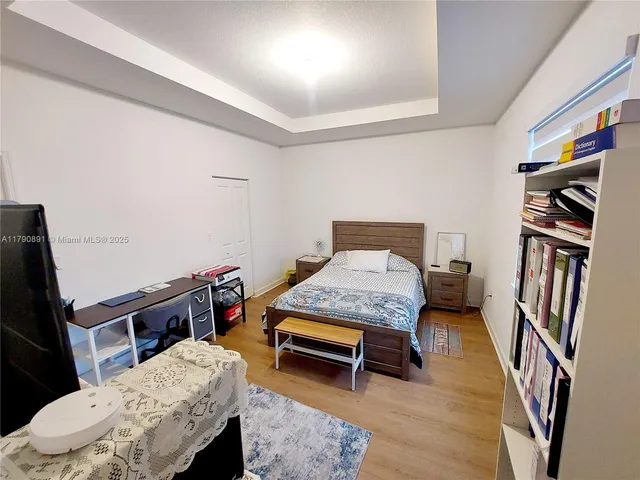 a bedroom with a bed and a dresser