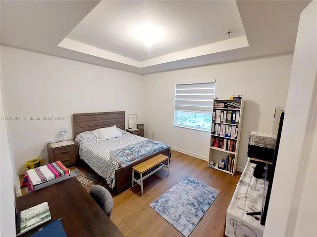 a living room with furniture and a book shelf