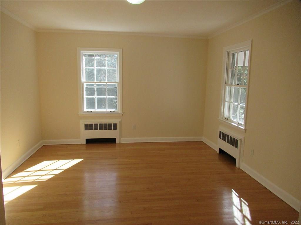 11 Burnt Swamp Road Woodbridge, CT 06525 - Photo 16 of 29 an empty room with wooden floor and windows