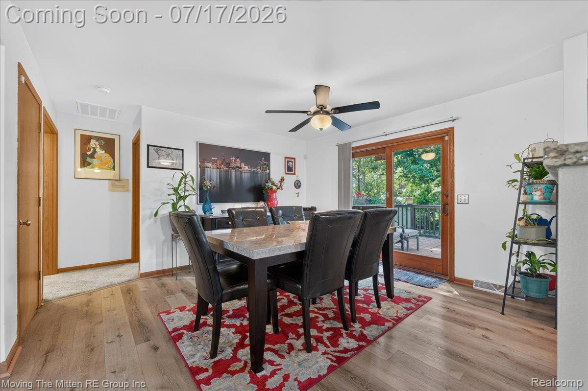 40162 Alden Road Belleville, MI 48111 - Photo 10 of 67 Dining area featuring wood-finish flooring, a ceiling fan, and access to an exterior deck through sliding glass doors