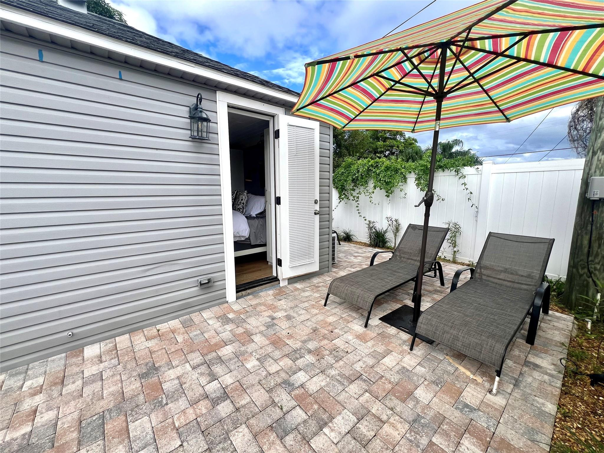12 Southwest 6th Street Delray Beach, FL 33444 - Photo 8 of 9 a view of a patio with a table and chairs under an umbrella