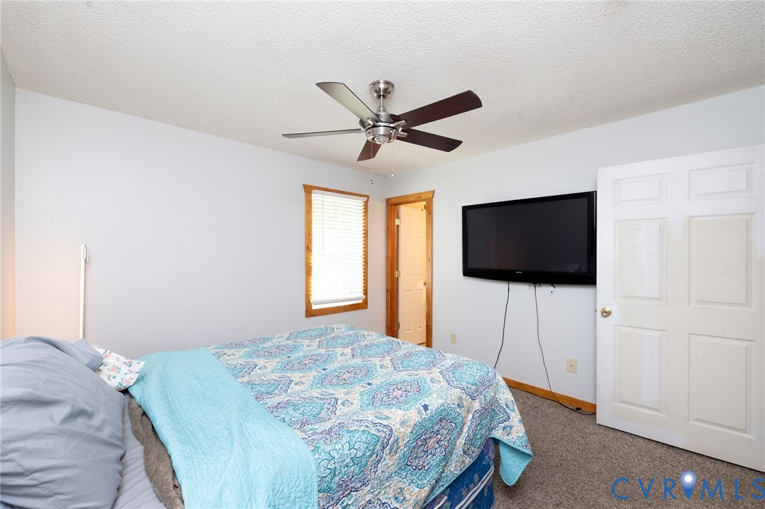 460 Horseshoe Road Jarratt, VA 23867 - Photo 14 of 24 a bedroom with a bed and a flat screen tv