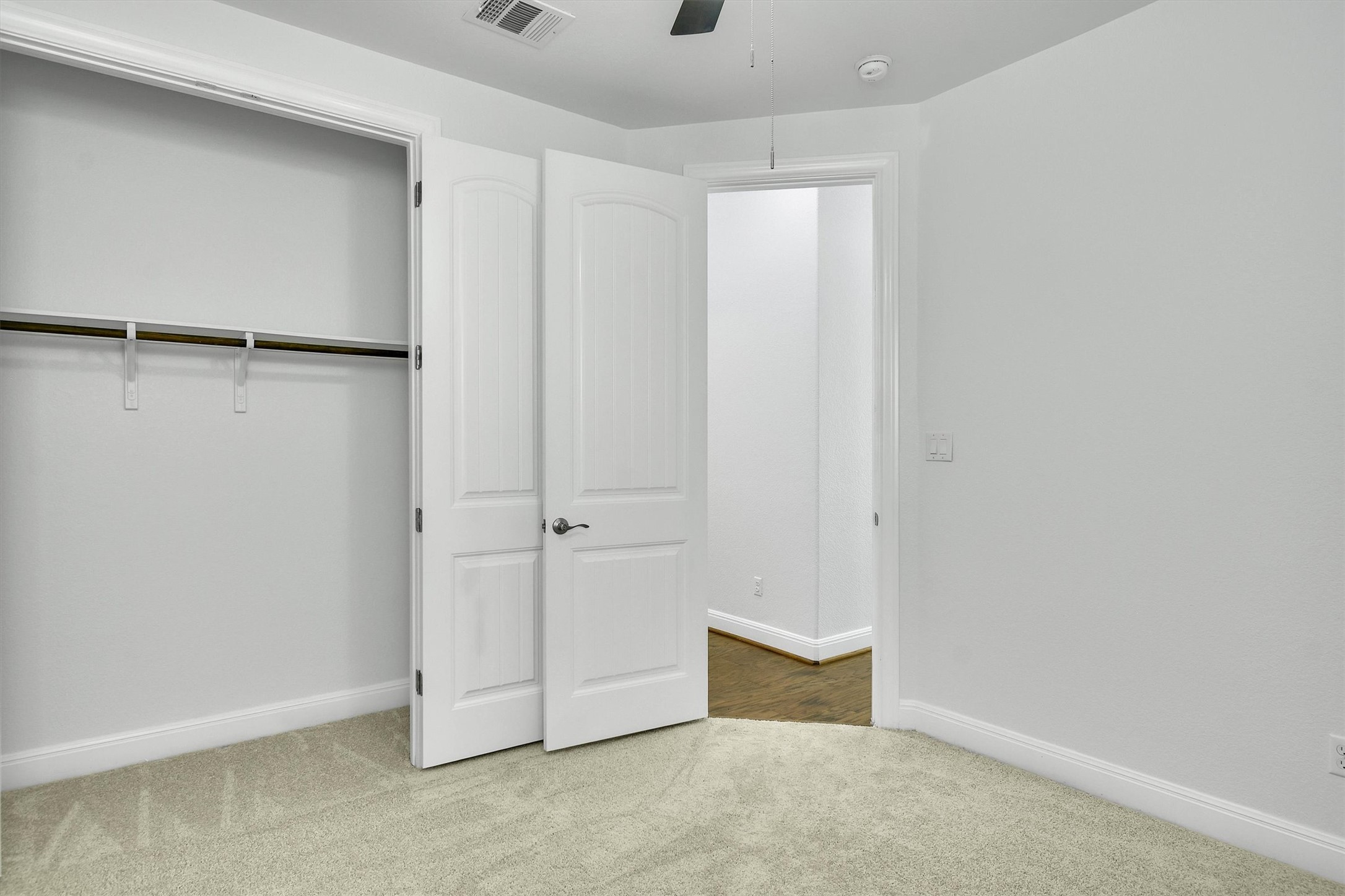 2325 Blended Tree Ranch Drive Leander, TX 78641 - Photo 24 of 35 A well-lit bedroom with plush carpeting and a convenient closet, awaiting your personal touch.