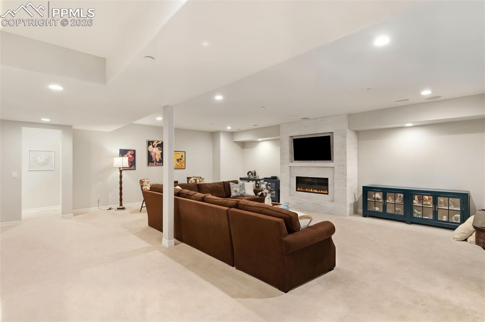 5318 Rocking Tree Grove Colorado Springs, CO 80906 - Photo 27 of 49 Anchored by a second striking gas fireplace, the basement living space provides a cozy, environment ideal for late-night movie screenings or relaxed winter evenings
