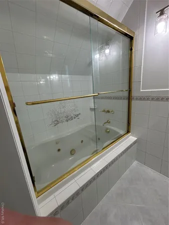 a bathroom with a shower and a mirror