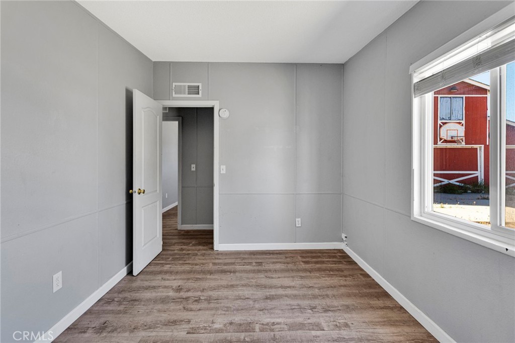 8074 Mira Mar Road Phelan, CA 92371 - Photo 24 of 49 a view of hallway with window and wooden floor