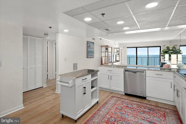 a kitchen with granite countertop cabinets stainless steel appliances and a sink