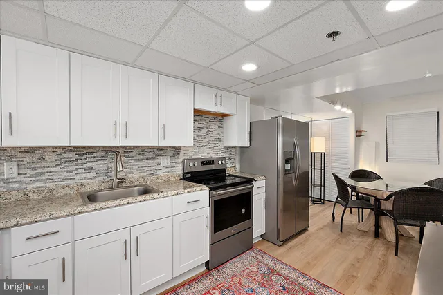 a kitchen with a stove sink and refrigerator