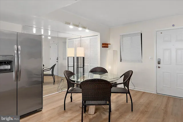 a view of a dining room with furniture and wooden floor