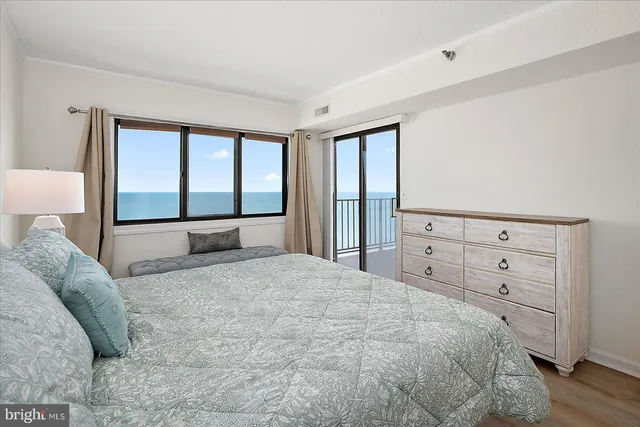 a bedroom with a large window and a bed