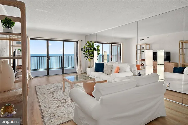 a living room with furniture a fireplace and a table
