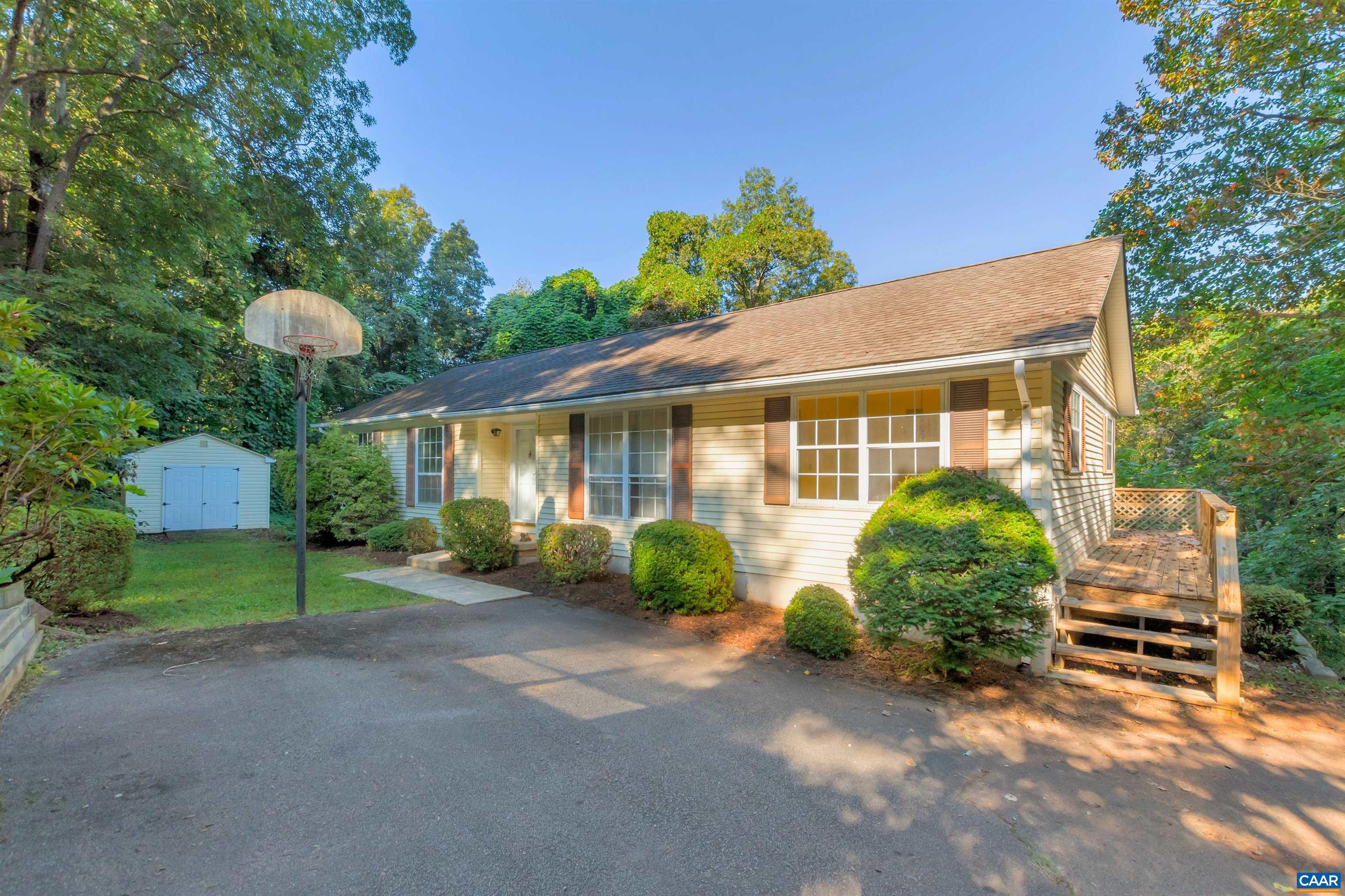 a view of a house with a yard and sitting area