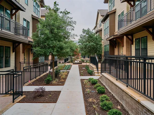 a view of a patio with table and chairs and potted plants