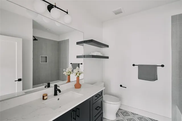 a bathroom with a sink toilet and mirror